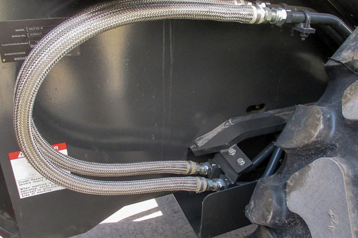 Boom cylinder hose guards and wraps